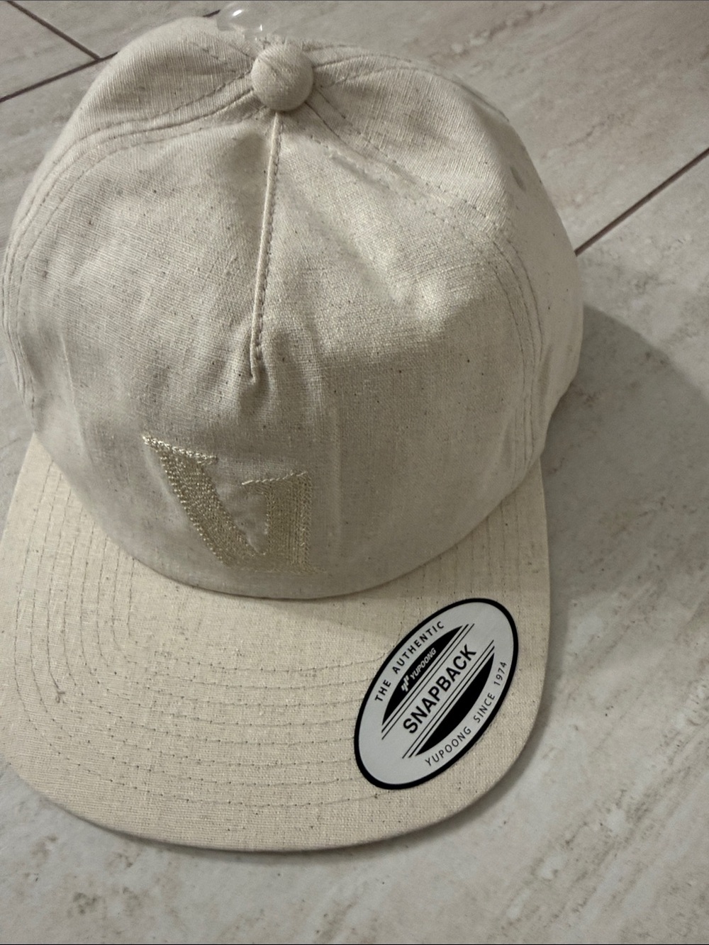 Vuori Neutral Cream Snapback Hat with Embroidered 'V'